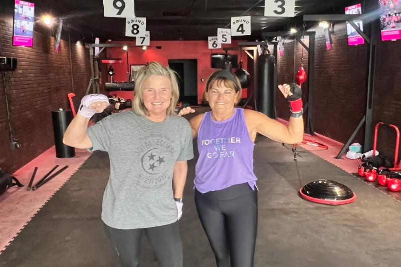 Two 9Round Murfreesboro TN members posing together after a kickboxing fitness workout
