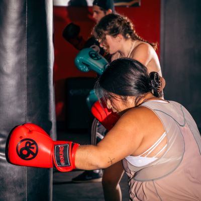 Trainer guiding a member through kickboxing rounds at 9Round Lakeview on Broadway in Chicago