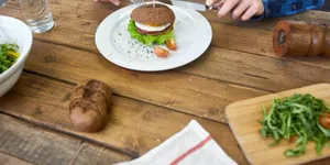 Balanced meal with a hamburger and fresh ingredients representing mindful eating and portion control