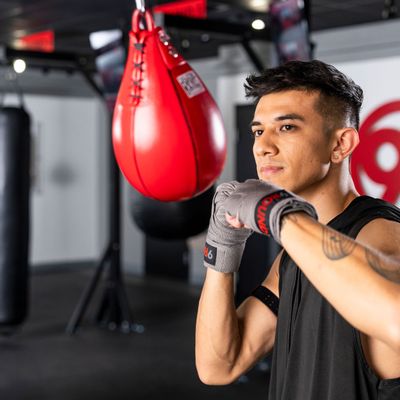 Young man training at 9Round on the speed bag to build strength and endurance