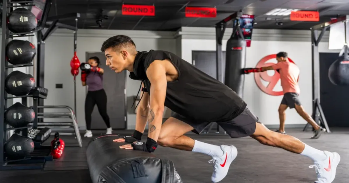 Member performing an incline push-up on a bag during 9Round bodyweight training.