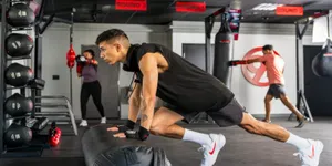 Member performing an incline push-up on a bag during 9Round bodyweight training.