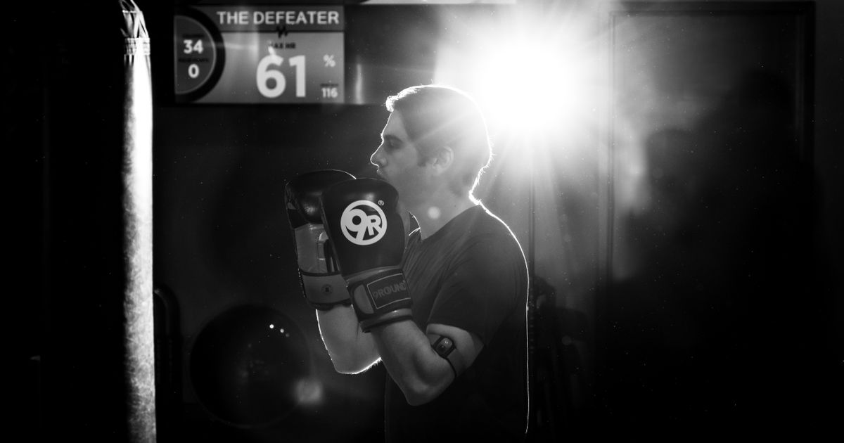 Beginner learning kickboxing with a trainer at 9Round Wicker Park on Division Street in Chicago