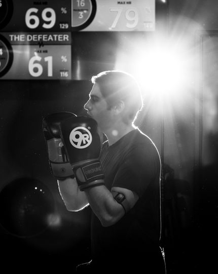 Beginner learning kickboxing with a trainer at 9Round Wicker Park on Division Street in Chicago