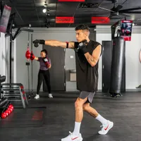 Man throwing a jab during a coached 9Round kickboxing session at a functional training gym