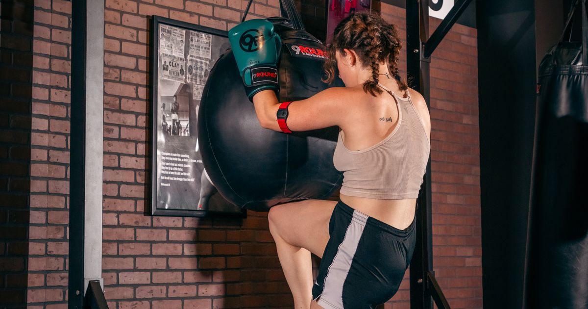 9Round trainer guiding a member through a kickboxing workout at the Wicker Park studio on Division Street