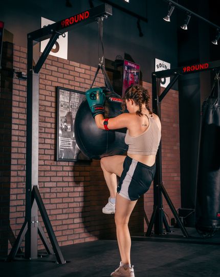 9Round trainer guiding a member through a kickboxing workout at the Wicker Park studio on Division Street