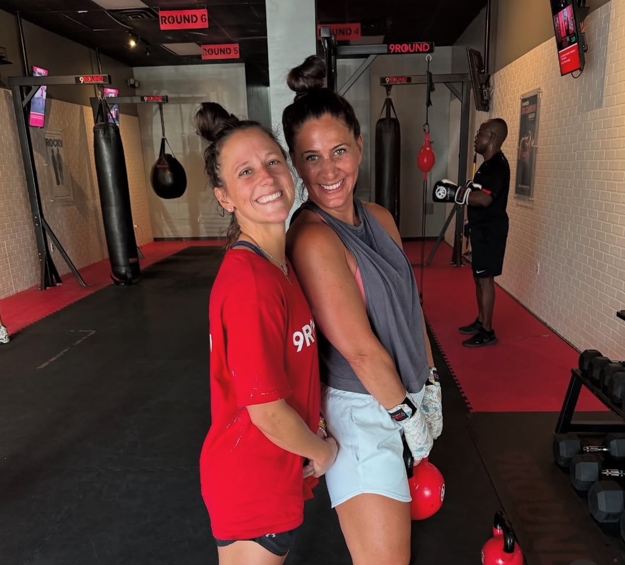 9Round owner posing for a photo with a 9Round member
