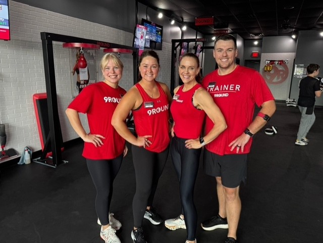9Round owner with her 9Round trainers at the studio” 
     style=