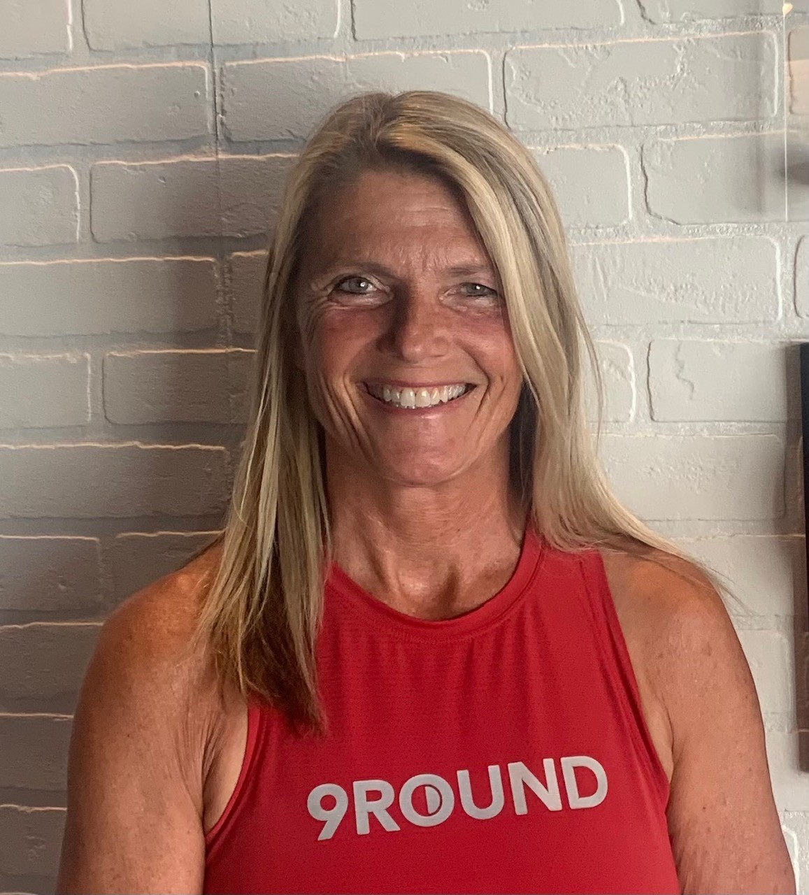 9Round female owner headshot in her studio” 
     style=