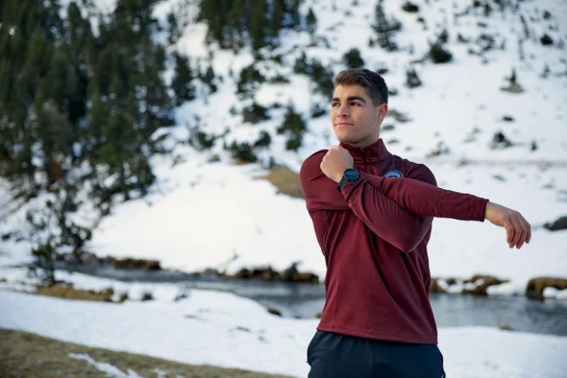 Man warming up outdoors before a cold weather workout to prepare muscles and prevent stiffness